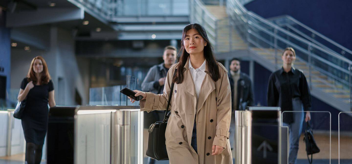 Woman walking through turnstiles